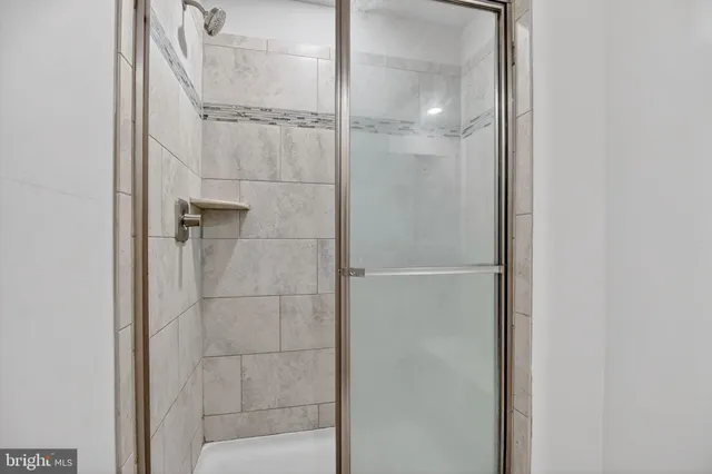a bathroom with a glass shower door