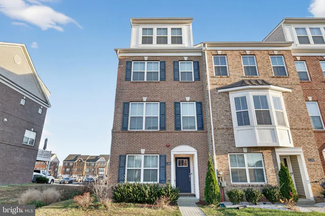 a front view of a building with a yard