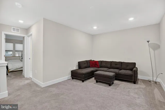 a living room with furniture and a walk in closet