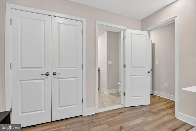 a view of a hallway with wooden floor