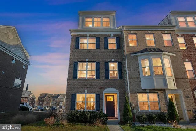 a front view of a residential apartment building with a yard