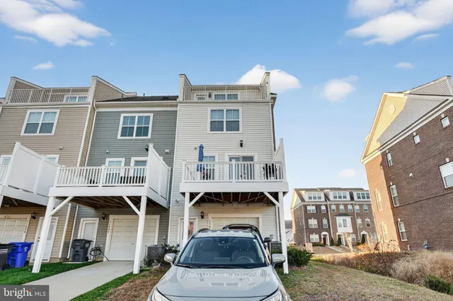 a front view of a residential apartment building with a yard