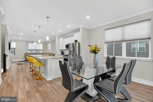a dining room with furniture and wooden floor