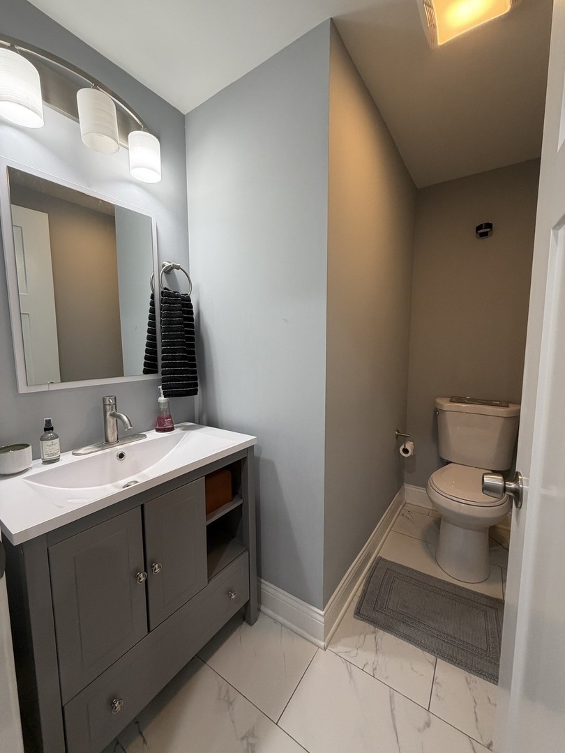 473 East Elm Street Sycamore, IL 60178 - Photo 11 of 21 a spacious bathroom with a toilet sink and mirror