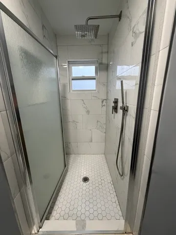 a room with gym equipment and wooden floor