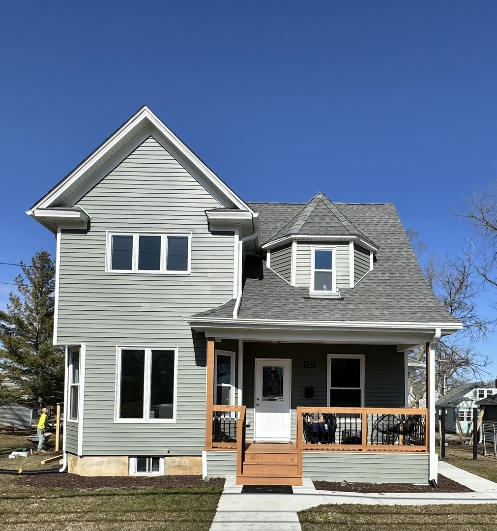 473 East Elm Street Sycamore, IL 60178 - Photo 2 of 21 a front view of a house with garden