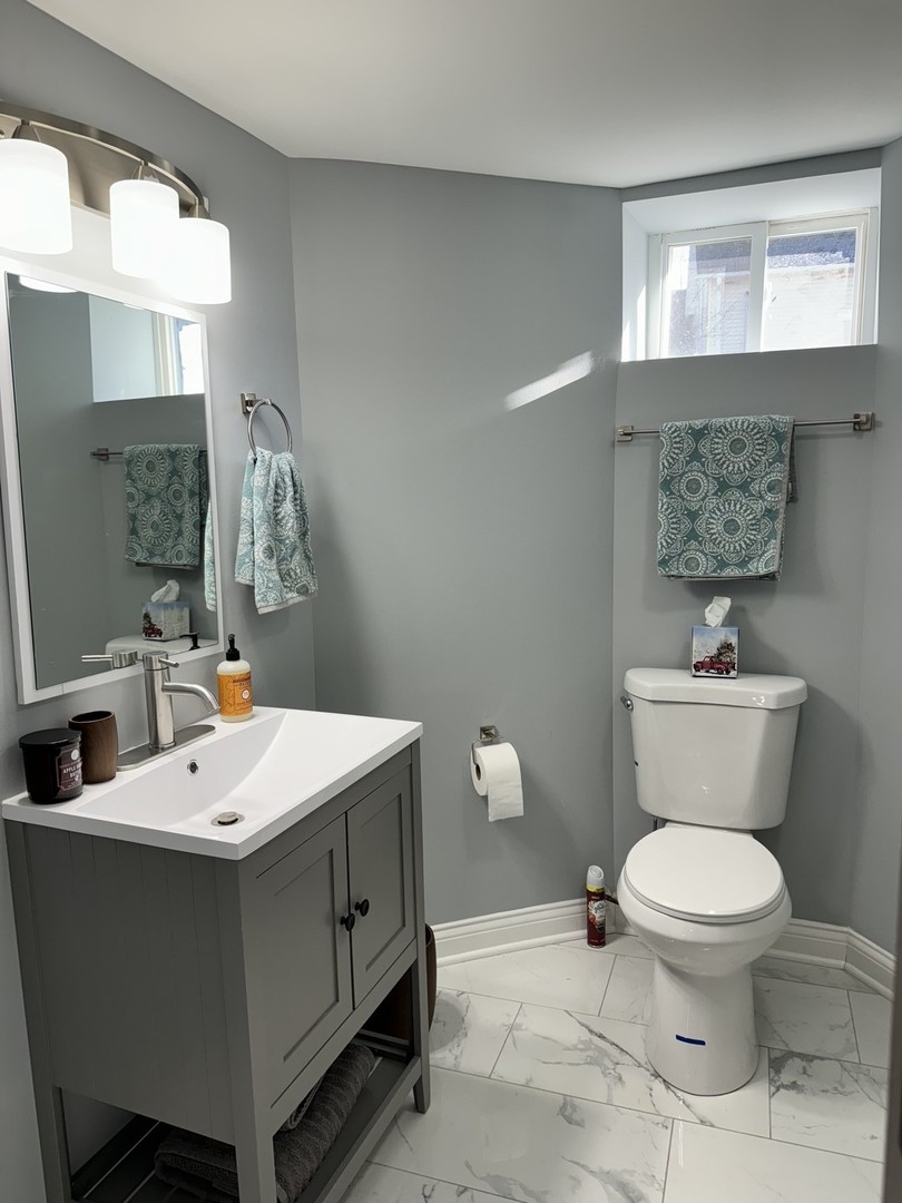473 East Elm Street Sycamore, IL 60178 - Photo 21 of 21 a bathroom with a toilet sink and mirror