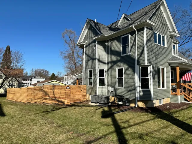 a view of a house with swimming pool and sitting area