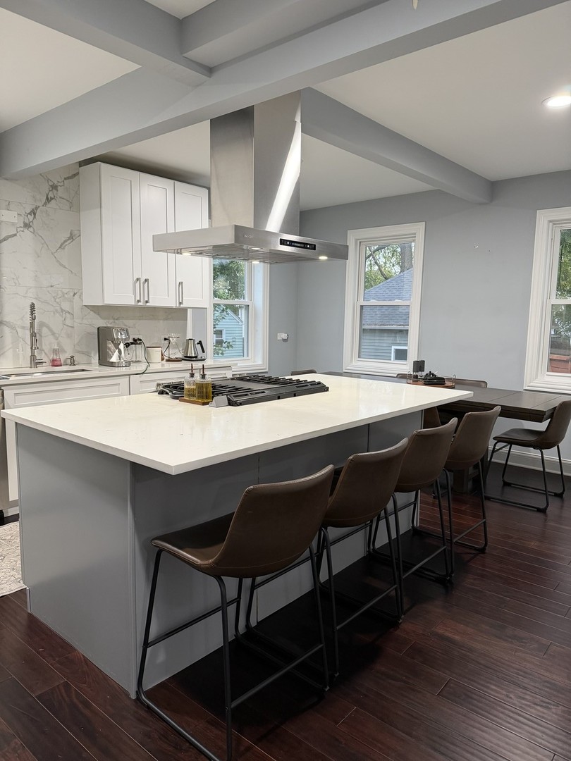 473 East Elm Street Sycamore, IL 60178 - Photo 9 of 21 a kitchen with a dining table chairs and wooden floor