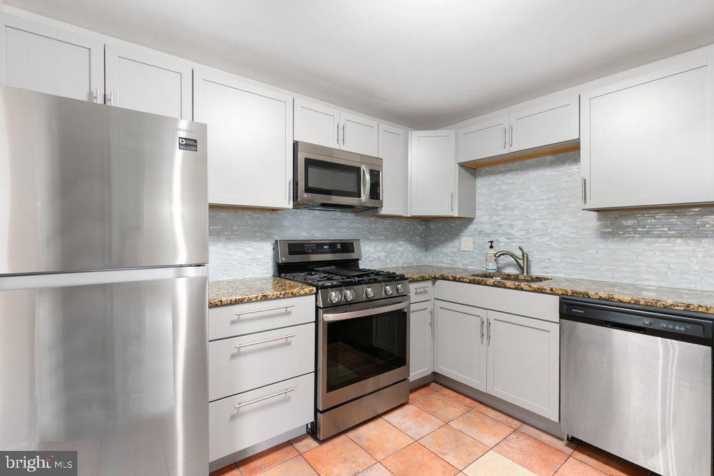 19027 Mills Choice Road, Unit 4 Gaithersburg, MD 20886 - Photo 11 of 26 a kitchen with cabinets stainless steel appliances and a sink