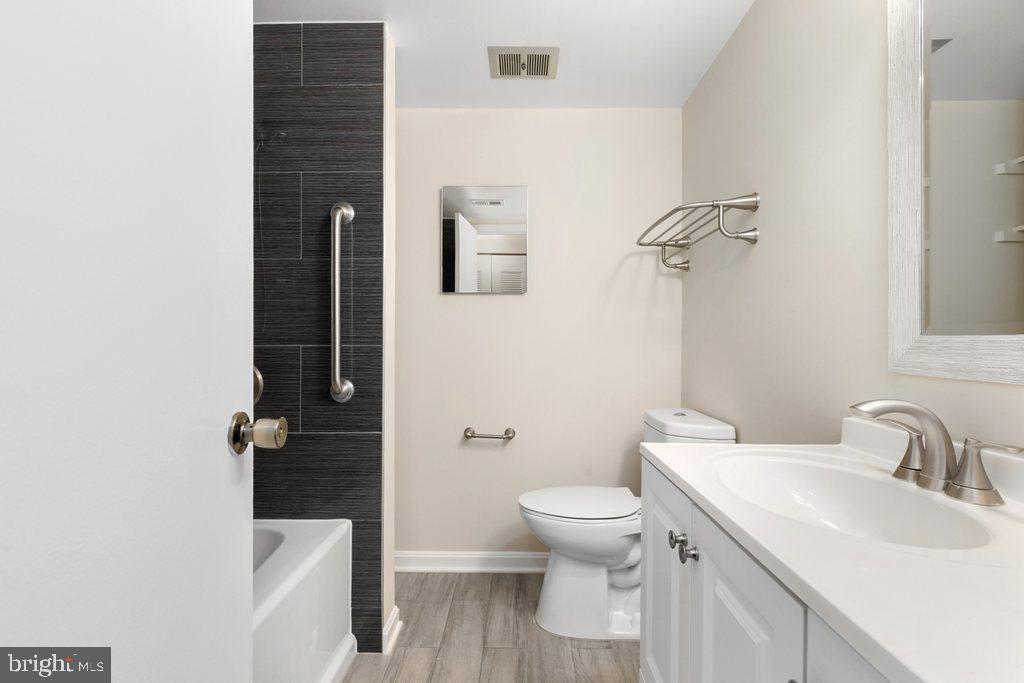 19027 Mills Choice Road, Unit 4 Gaithersburg, MD 20886 - Photo 12 of 26 a bathroom with a sink toilet and shower