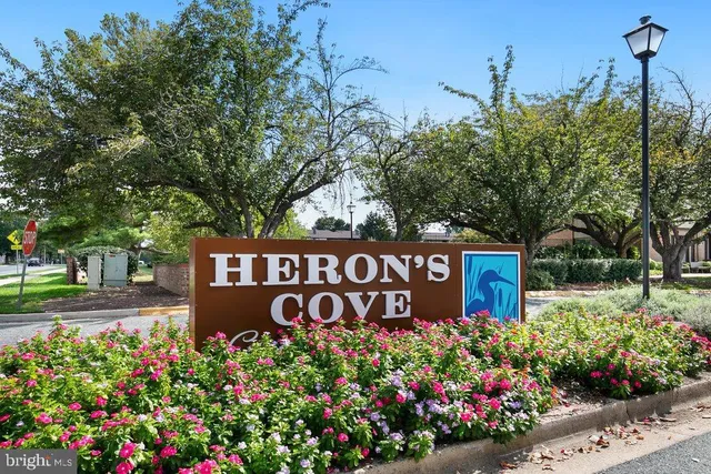 a sign that is in front of flowers