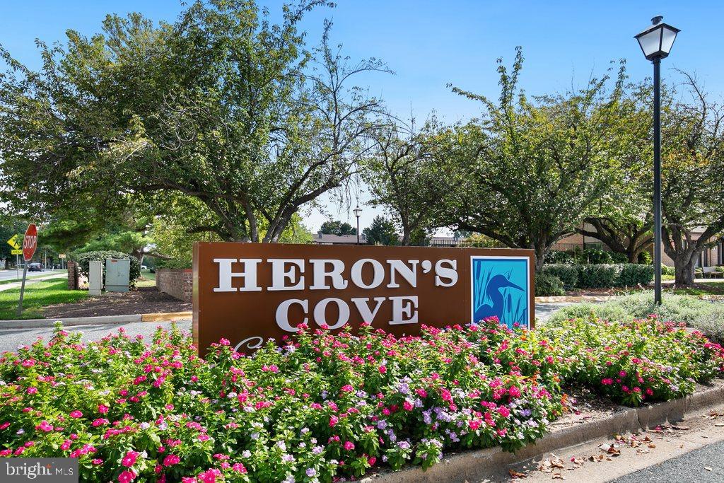 19027 Mills Choice Road, Unit 4 Gaithersburg, MD 20886 - Photo 2 of 26 a sign that is in front of flowers