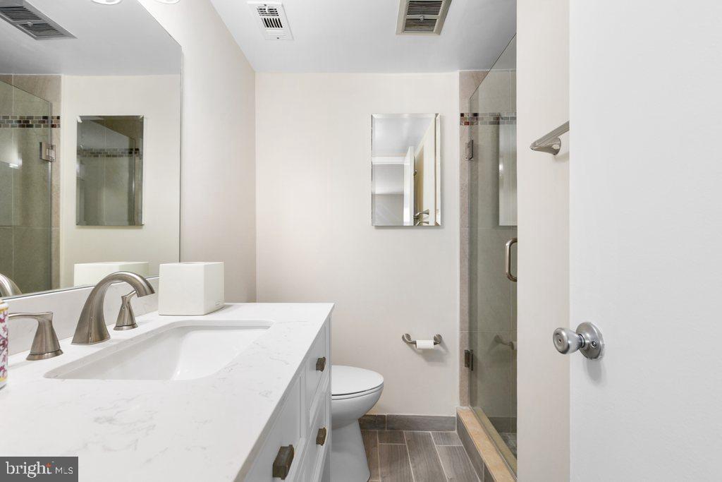 19027 Mills Choice Road, Unit 4 Gaithersburg, MD 20886 - Photo 21 of 26 a bathroom with a sink toilet and shower