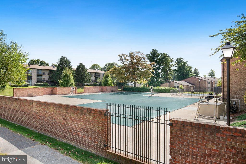 19027 Mills Choice Road, Unit 4 Gaithersburg, MD 20886 - Photo 24 of 26 a view of a swimming pool and a porch