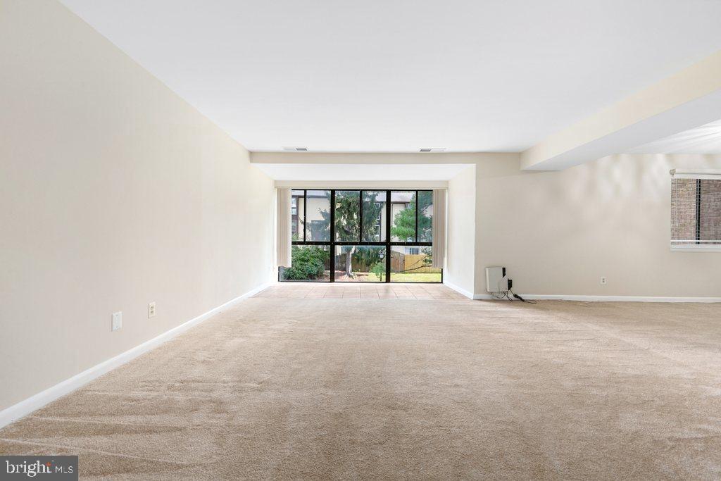 19027 Mills Choice Road, Unit 4 Gaithersburg, MD 20886 - Photo 3 of 26 a view of an empty room with a window