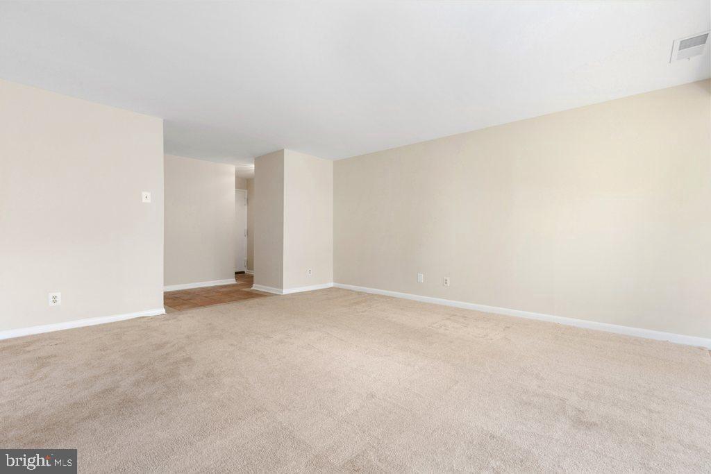 19027 Mills Choice Road, Unit 4 Gaithersburg, MD 20886 - Photo 5 of 26 an empty room with an entryway