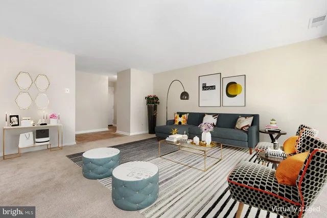 a living room with furniture and painting on the wall