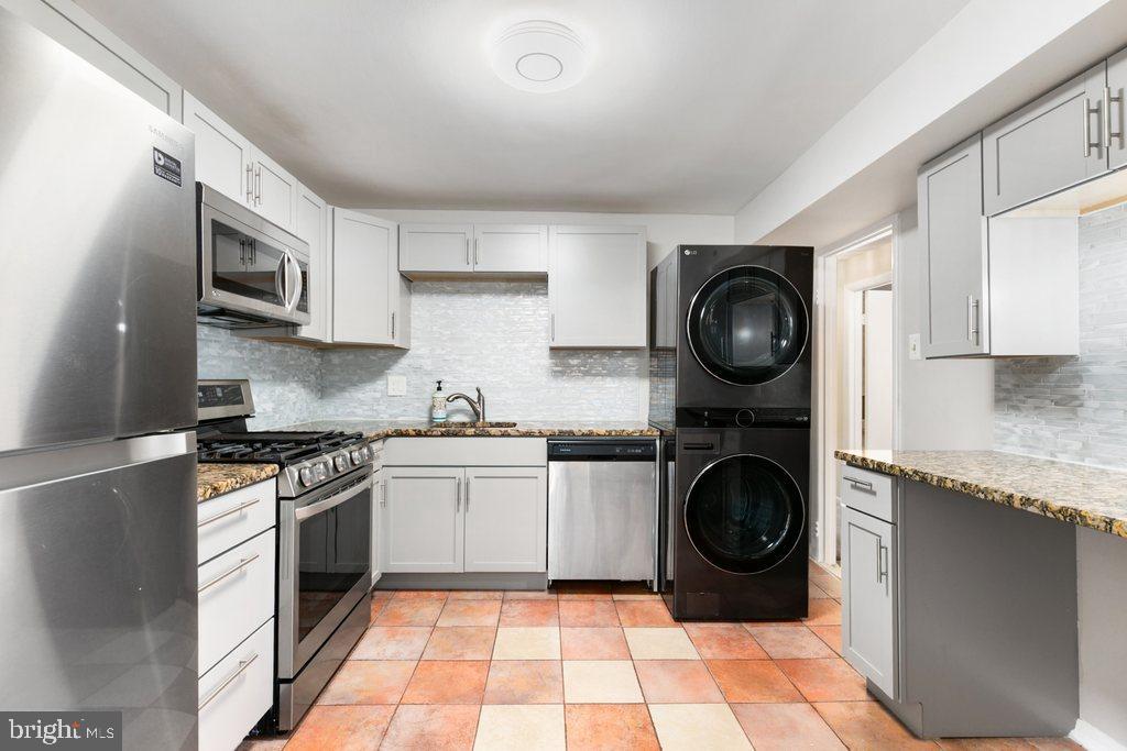 19027 Mills Choice Road, Unit 4 Gaithersburg, MD 20886 - Photo 10 of 26 a kitchen with stainless steel appliances granite countertop a sink a stove top oven and cabinets