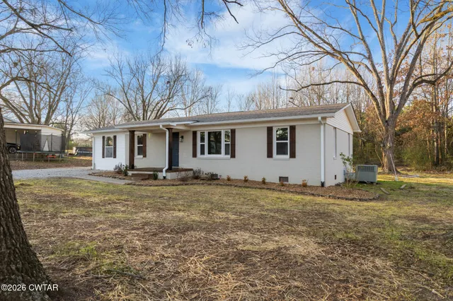 a view of a yard with a house in the background