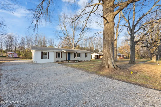 a view of a house with a yard covered in snow