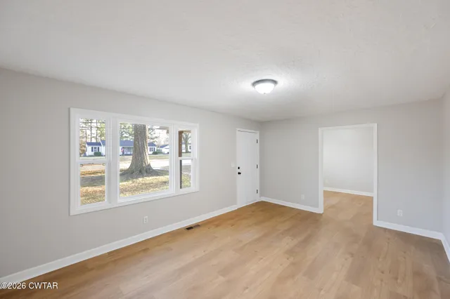 a view of an empty room with a window
