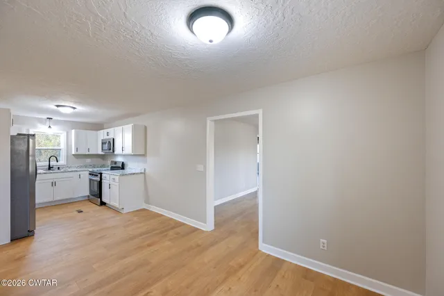 a view of kitchen and wooden floor