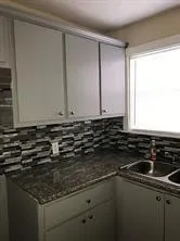 a kitchen with a sink and cabinets