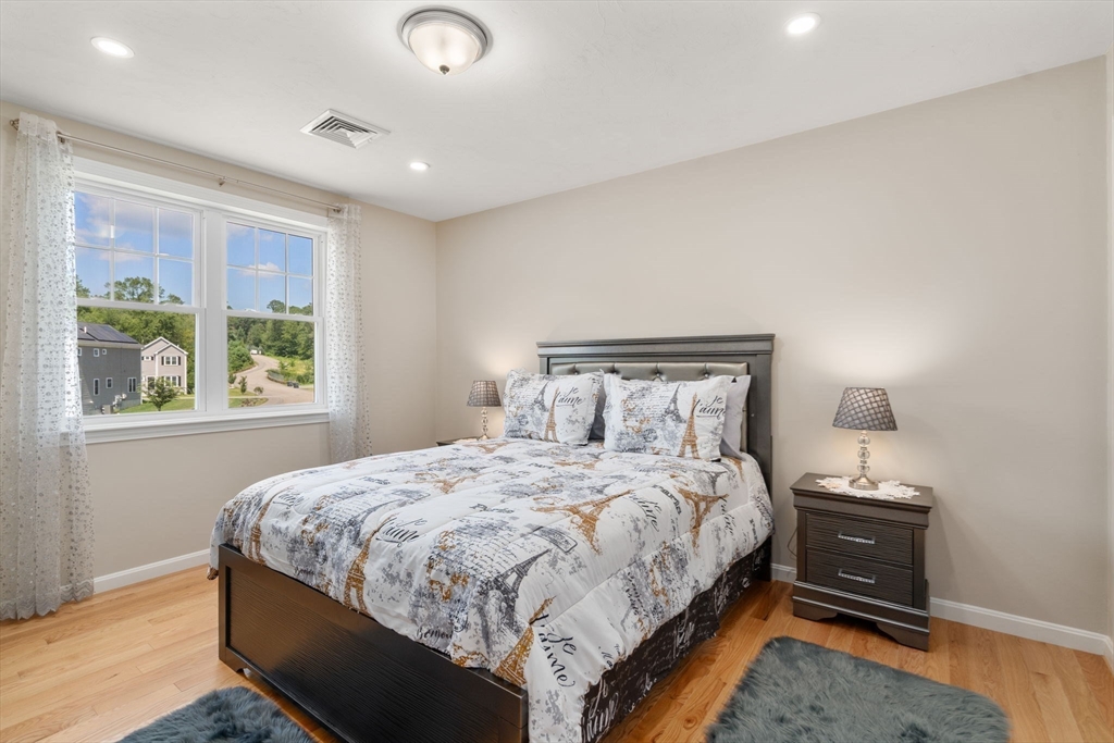 26 Brookview Lane, Unit 26 Mendon, MA 01756 - Photo 14 of 23 a bedroom with a bed and a window