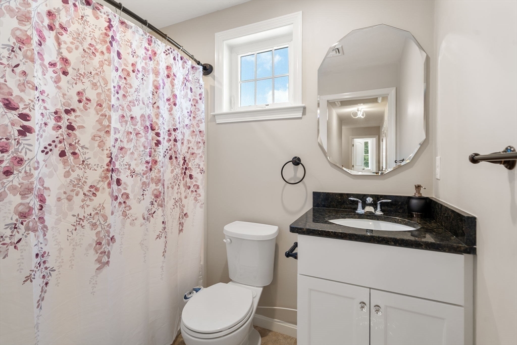 26 Brookview Lane, Unit 26 Mendon, MA 01756 - Photo 17 of 23 a bathroom with a granite countertop sink mirror vanity and toilet