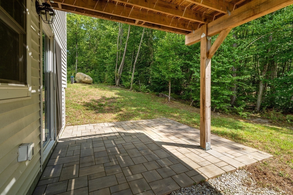 26 Brookview Lane, Unit 26 Mendon, MA 01756 - Photo 20 of 23 a view of a back yard from a room