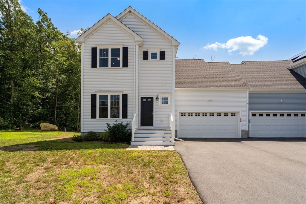 26 Brookview Lane, Unit 26 Mendon, MA 01756 - Photo 2 of 23 a front view of a house with a yard
