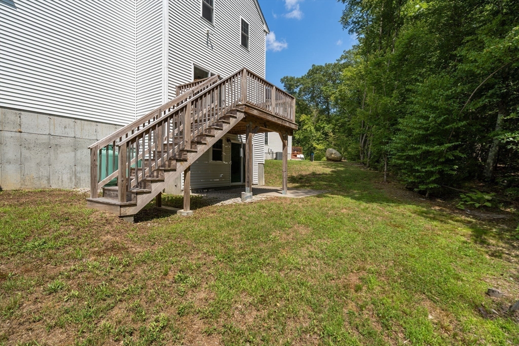 26 Brookview Lane, Unit 26 Mendon, MA 01756 - Photo 22 of 23 a view of an house with backyard and trees