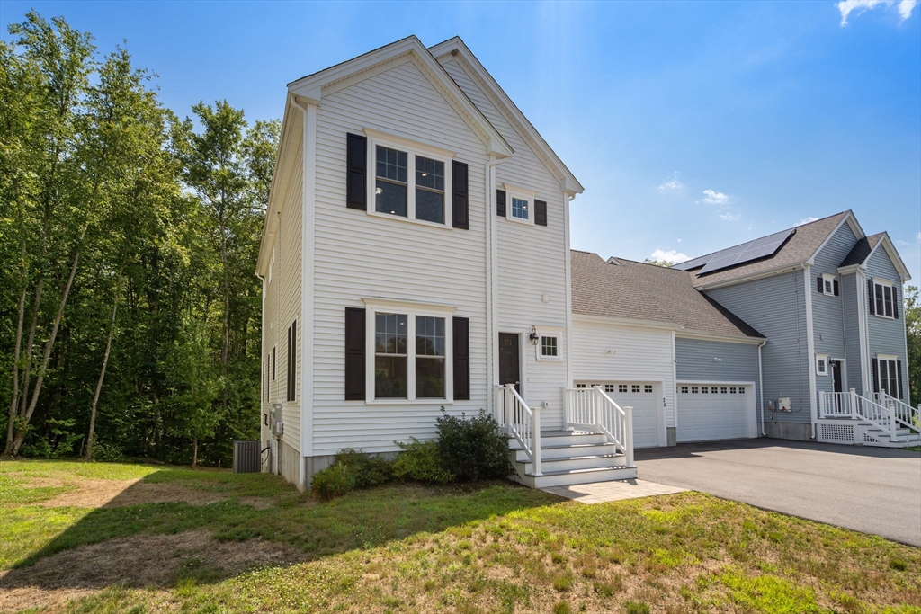 26 Brookview Lane, Unit 26 Mendon, MA 01756 - Photo 23 of 23 a front view of a house with a yard outdoor seating and yard