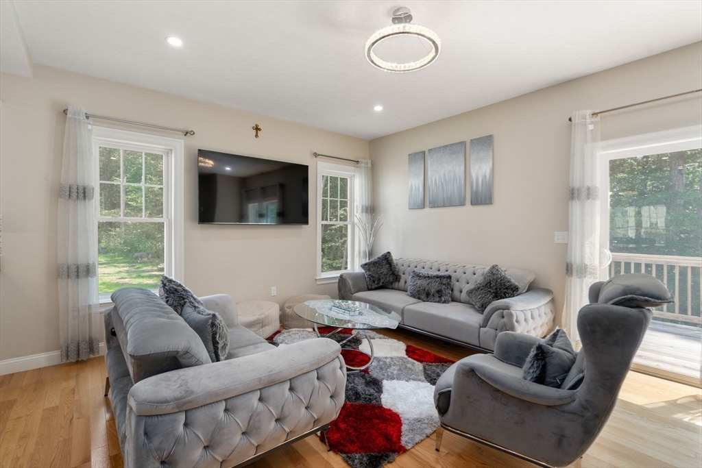 26 Brookview Lane, Unit 26 Mendon, MA 01756 - Photo 6 of 23 a living room with furniture and a flat screen tv