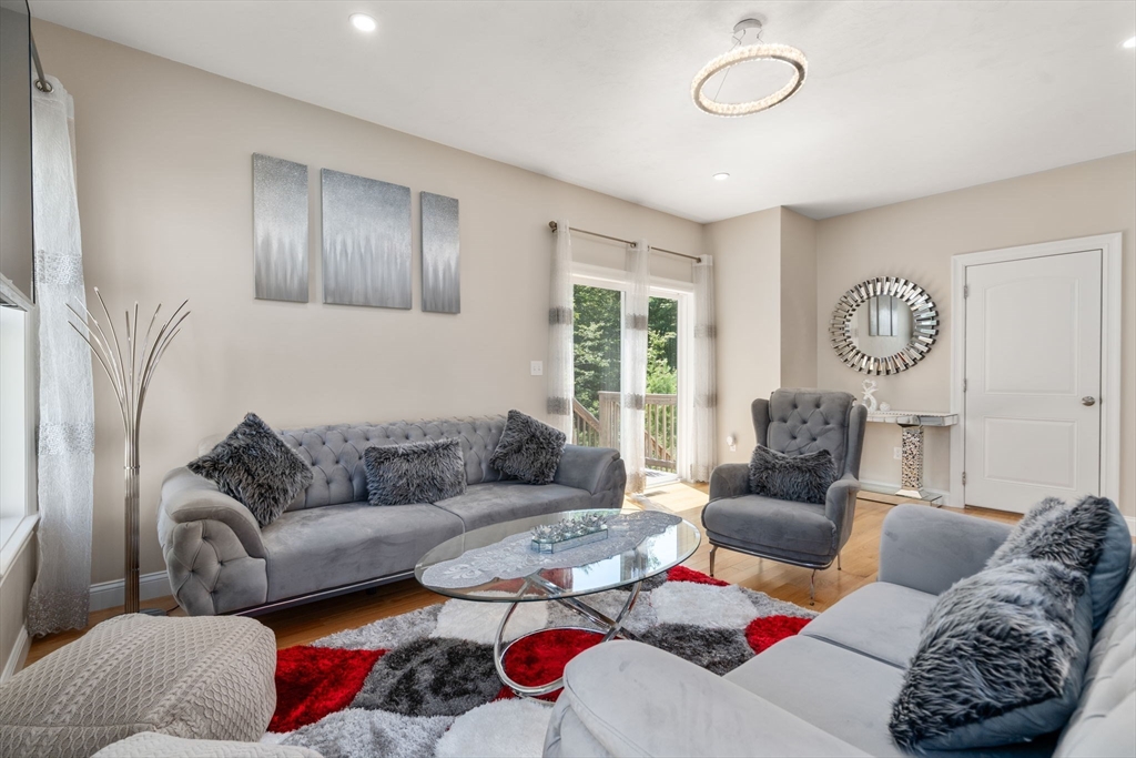 26 Brookview Lane, Unit 26 Mendon, MA 01756 - Photo 7 of 23 a living room with furniture and a large window