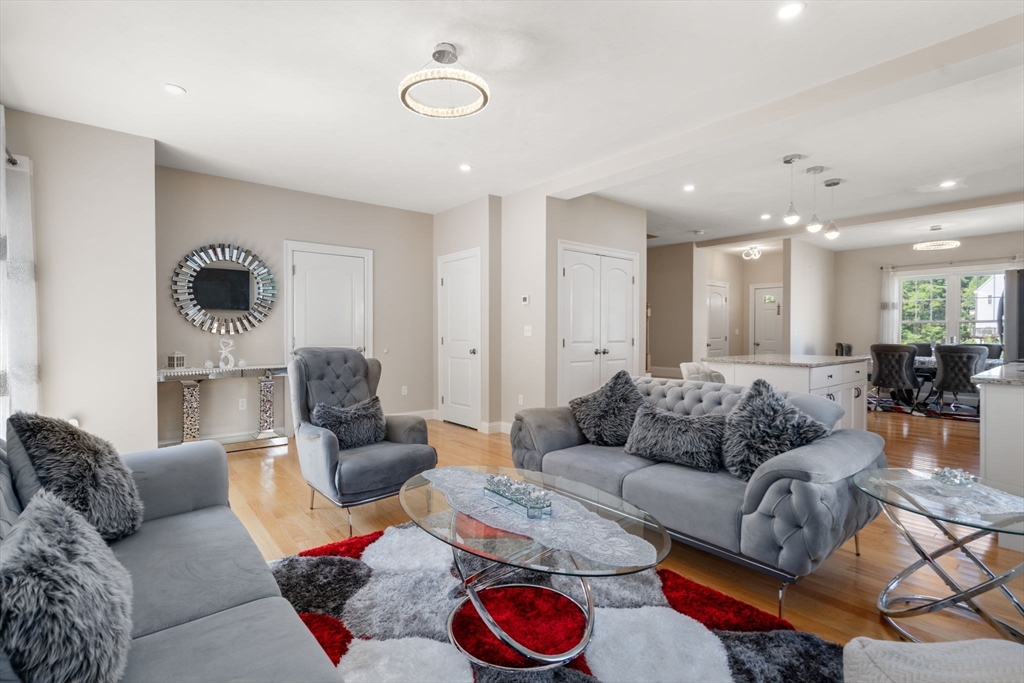 26 Brookview Lane, Unit 26 Mendon, MA 01756 - Photo 8 of 23 a living room with furniture kitchen and a table