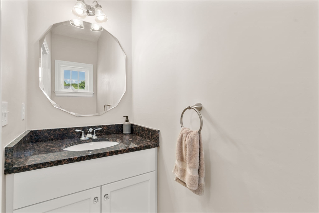 26 Brookview Lane, Unit 26 Mendon, MA 01756 - Photo 9 of 23 a bathroom with a granite countertop sink and a mirror