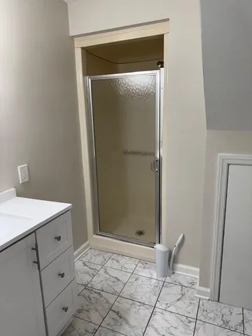 a bathroom with a shower and a sink