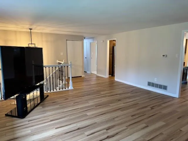 a view of a living room with wooden floor
