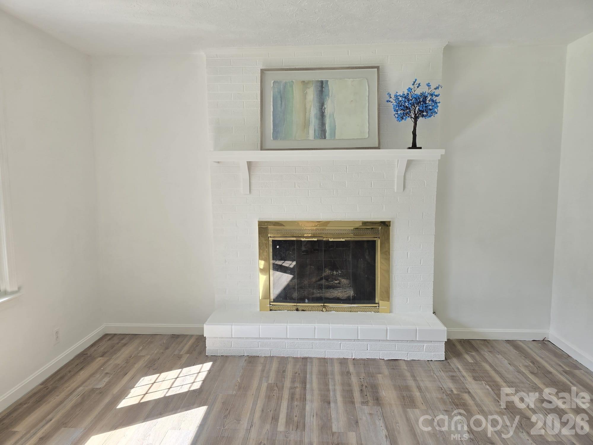 1797 Calvin Edney Road Mars Hill, NC 28754 - Photo 2 of 14 a living room with a fireplace
