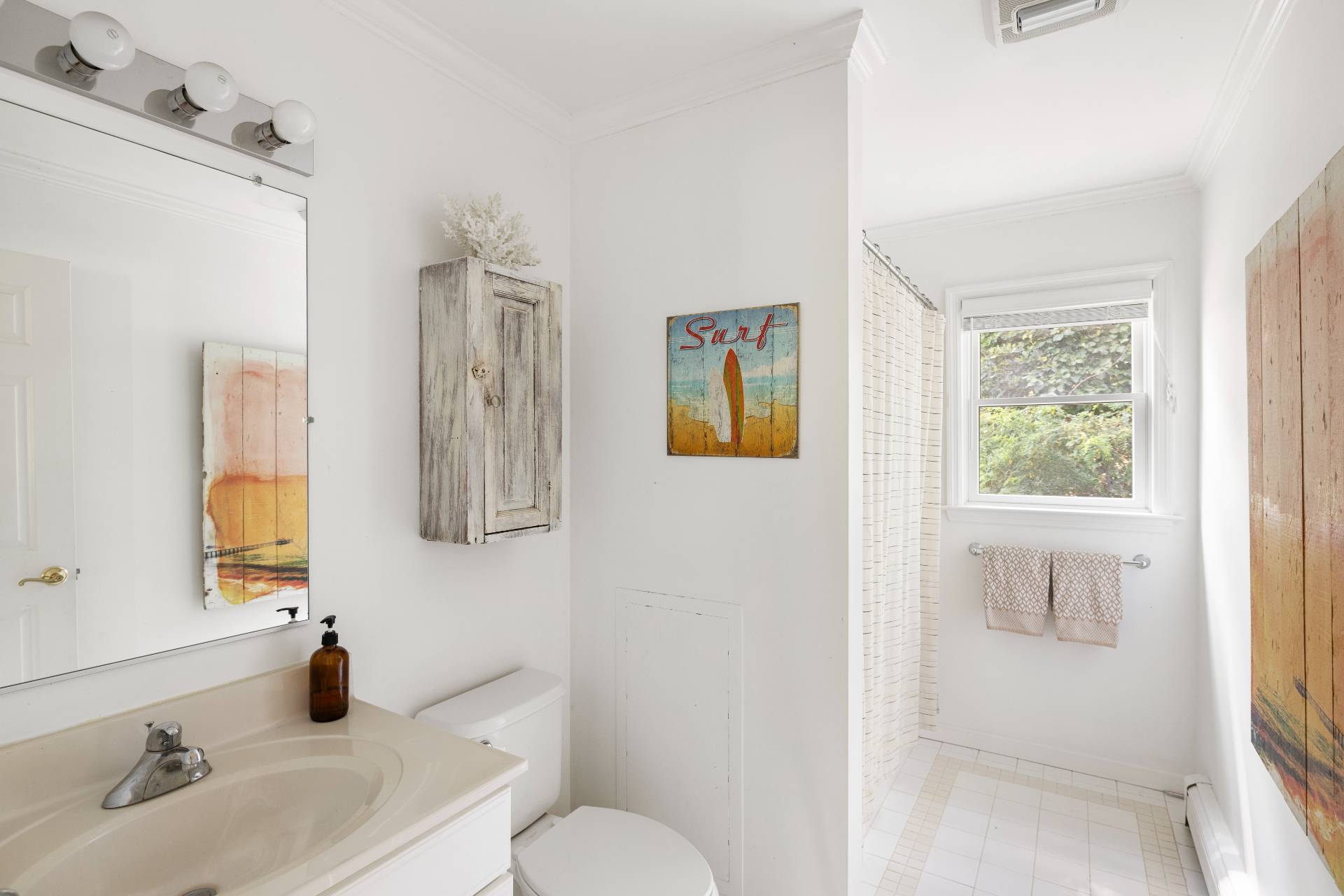 312 Noyack Road Southampton, NY 11968 - Photo 16 of 18 a bathroom with a sink and a mirror