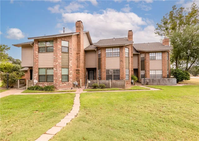 a view of a house with swimming pool and a yard