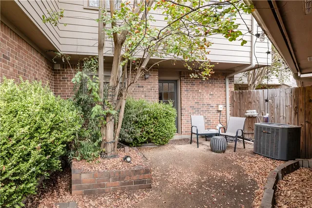 a view of a patio with table and chairs and potted plants