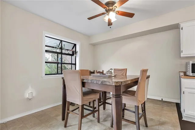 a view of a dining room with furniture and window