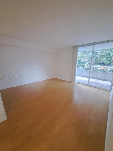 an empty room with large windows