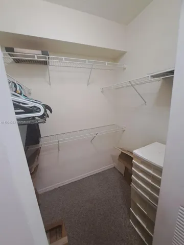 a view of storage and utility room with racks on the wall