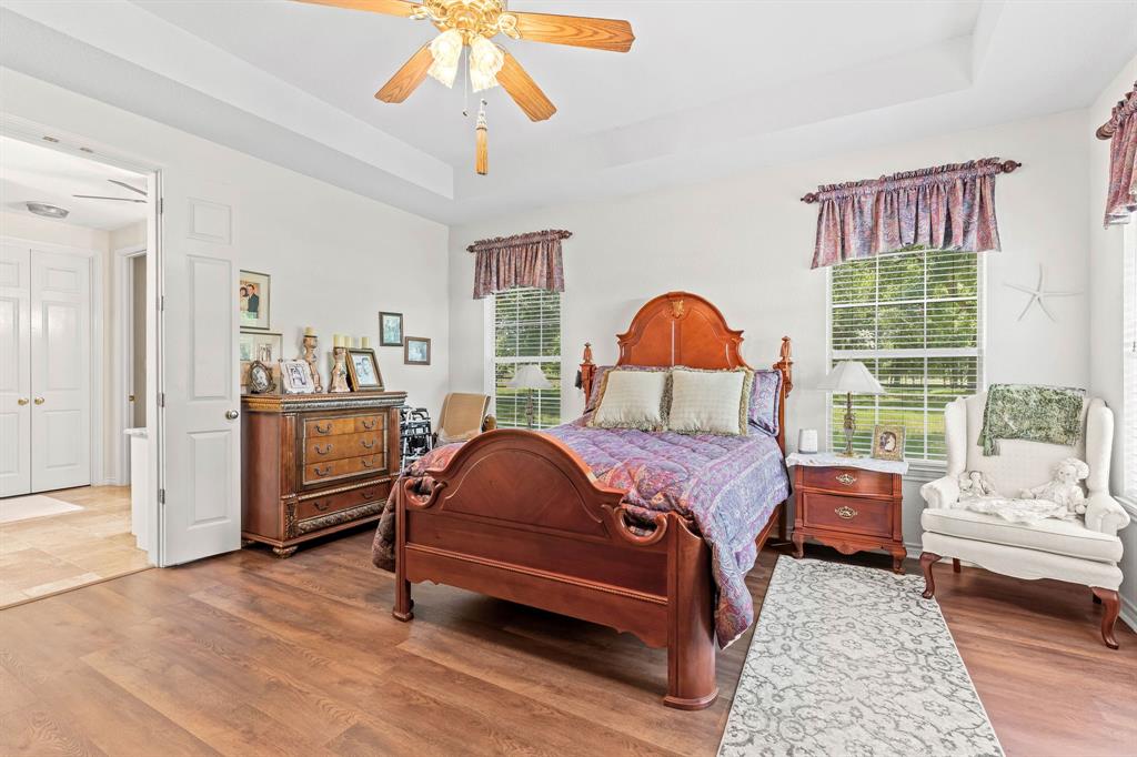 145 Indian Trail Decatur, TX 76234 - Photo 15 of 40 a bedroom with a bed and wooden floor