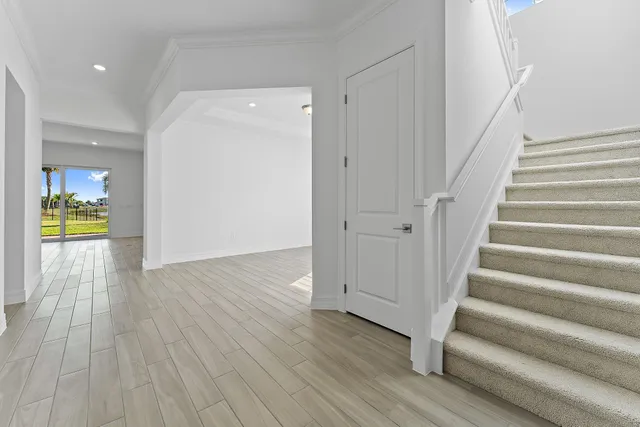 a kitchen with stainless steel appliances kitchen island granite countertop a sink a stove a refrigerator and island with wooden floor