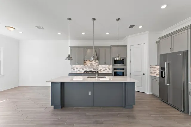 a view of a kitchen with a sink and a stove top oven